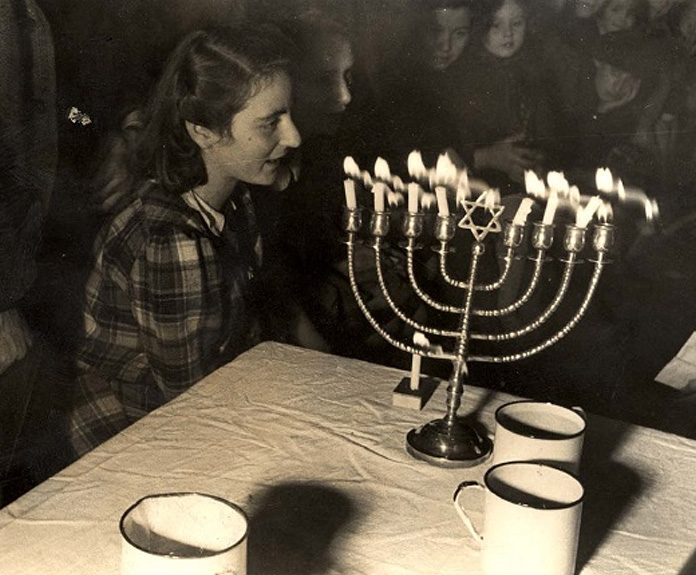 Lighting  candles on the seventh night of Hanukkah in Westerbork, Holland. Source: Yad Vashem